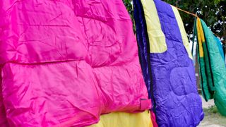 Sleeping bags air drying in line