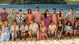 The cast of competitive reality series "Survivor 47" wearing colourful summer clothes pose on an exotic beach with the surf in the background