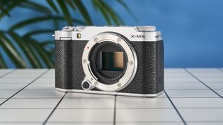 A Fujifilm X-M5 mirrorless vlogging camera in the silver colorway