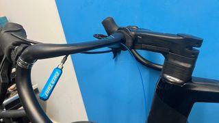Internal cable routing tool in use on mountain bike