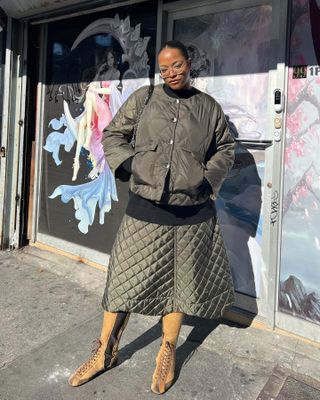 Fashion influencer Imani Randolph wearing a quilted olive green outfit in New York City.