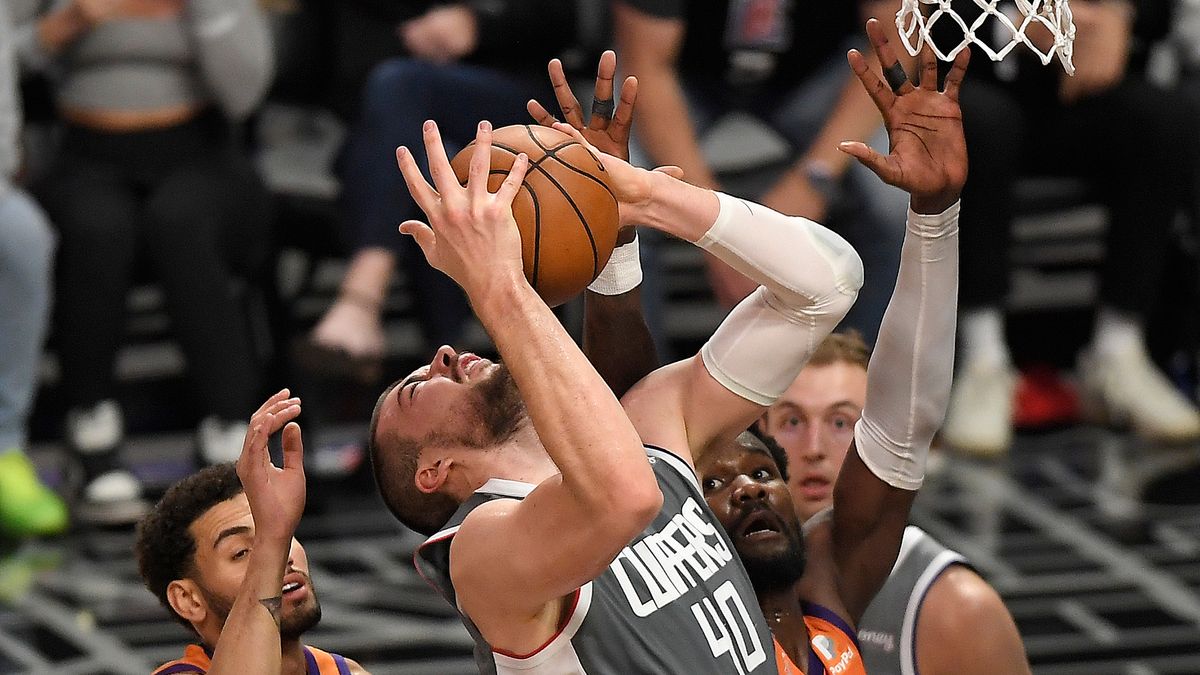 Ivica Zubac #40 of the LA Clippers grabs a rebound against the Phoenix Suns during the second half in game four of the Western Conference Finals at Staples Center on June 26, 2021 in Los Angeles, California.