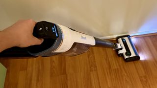 Shark Cordless Pro vacuum cleaning close to the baseboards in reviewer's home