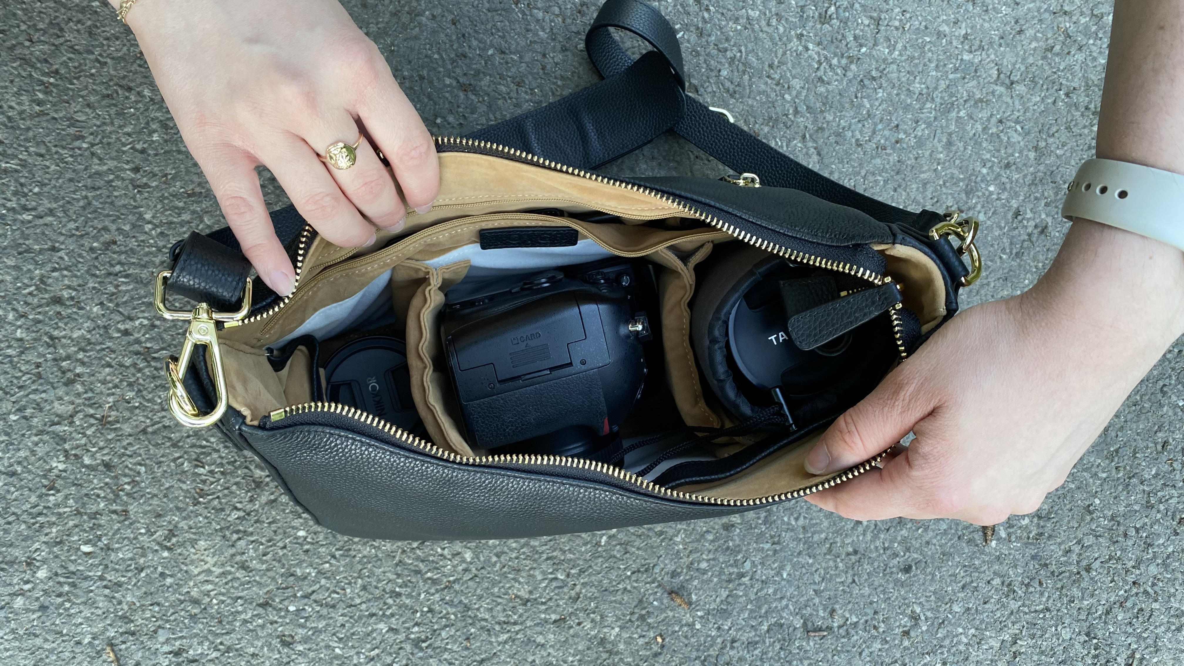 Person opening a Voygr 1 camera bag