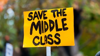 Yellow protest sign that says Save the Middle Class
