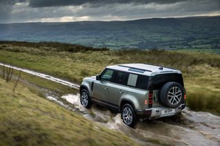 Land Rover Defender Hybrid offroading in mud