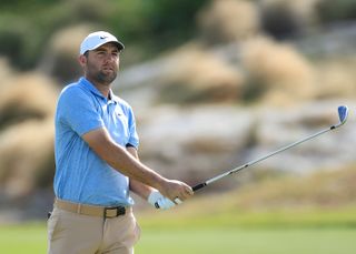 Scottie Scheffler watches his wedge shot