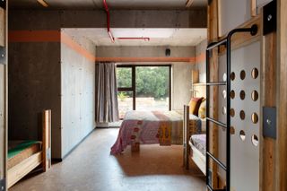 Bedrooms boasts concrete walls and bohemian bedsheets