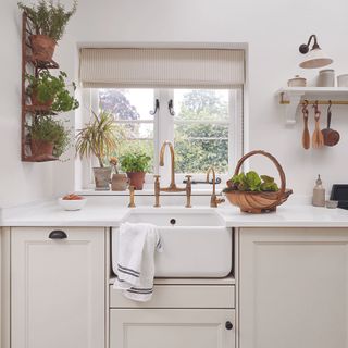 White shaker kitchen with white worktop and belfast sink