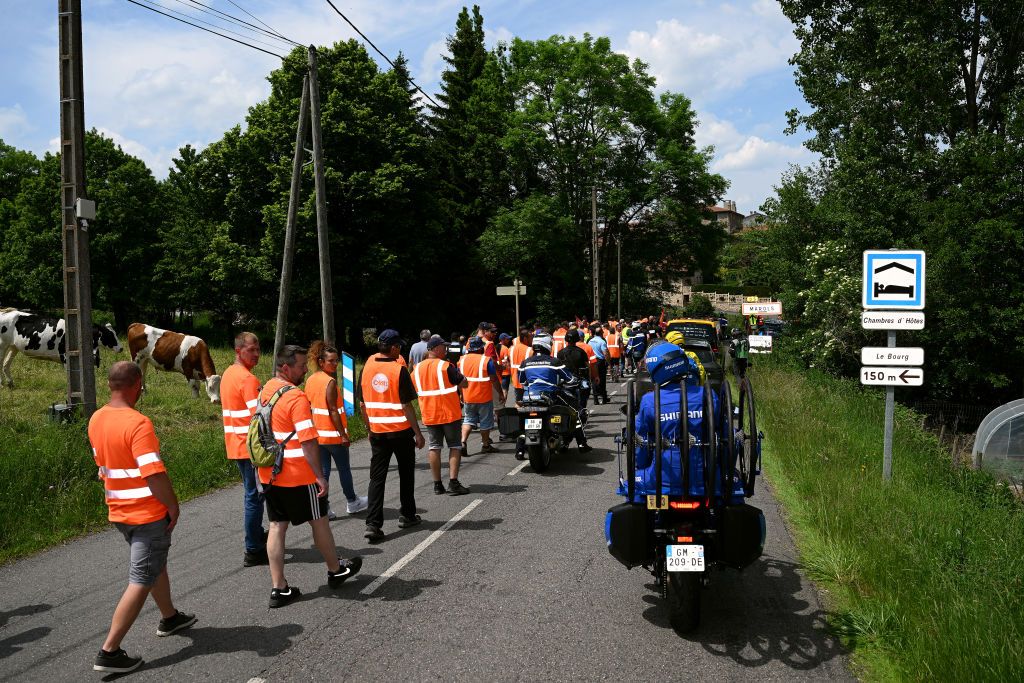 LE COTEAU FRANCE JUNE 06 Protesters block the road in Marols village during the 75th Criterium du Dauphine 2023 Stage 3 a 1941km stage from MonistrolsurLoire to Le Coteau UCIWT on June 06 2023 in Le Coteau France Photo by Dario BelingheriGetty Images