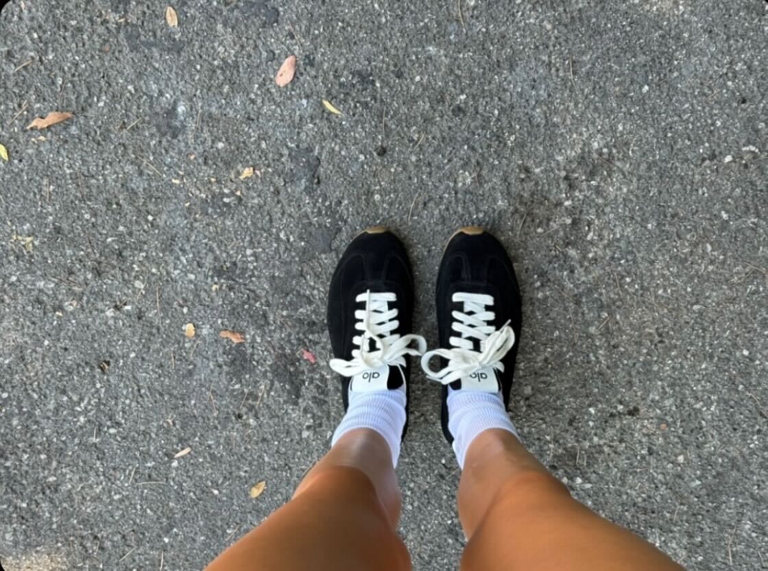 Kendall Jenner wearing a black-and-white workout set from Alo with the brand's new Sunset sneakers.