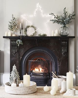 black fireplace with a large light up star