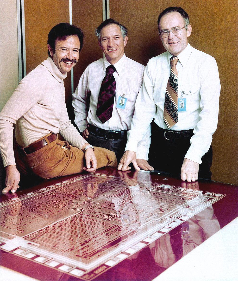 Andy Grove, Robert Noyce, and Gordon Moore stand next to the Intel 8080 rubylith in 1978
