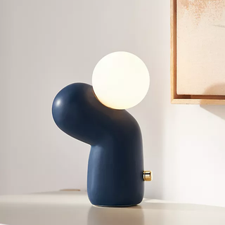 statuesque and modern table lamp with orb light