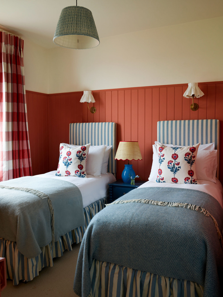 Red and off white bedroom walls with blue bedding