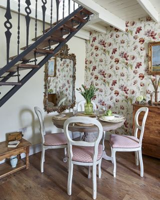 Dining set with stairs and decorative mirror and wooden floor