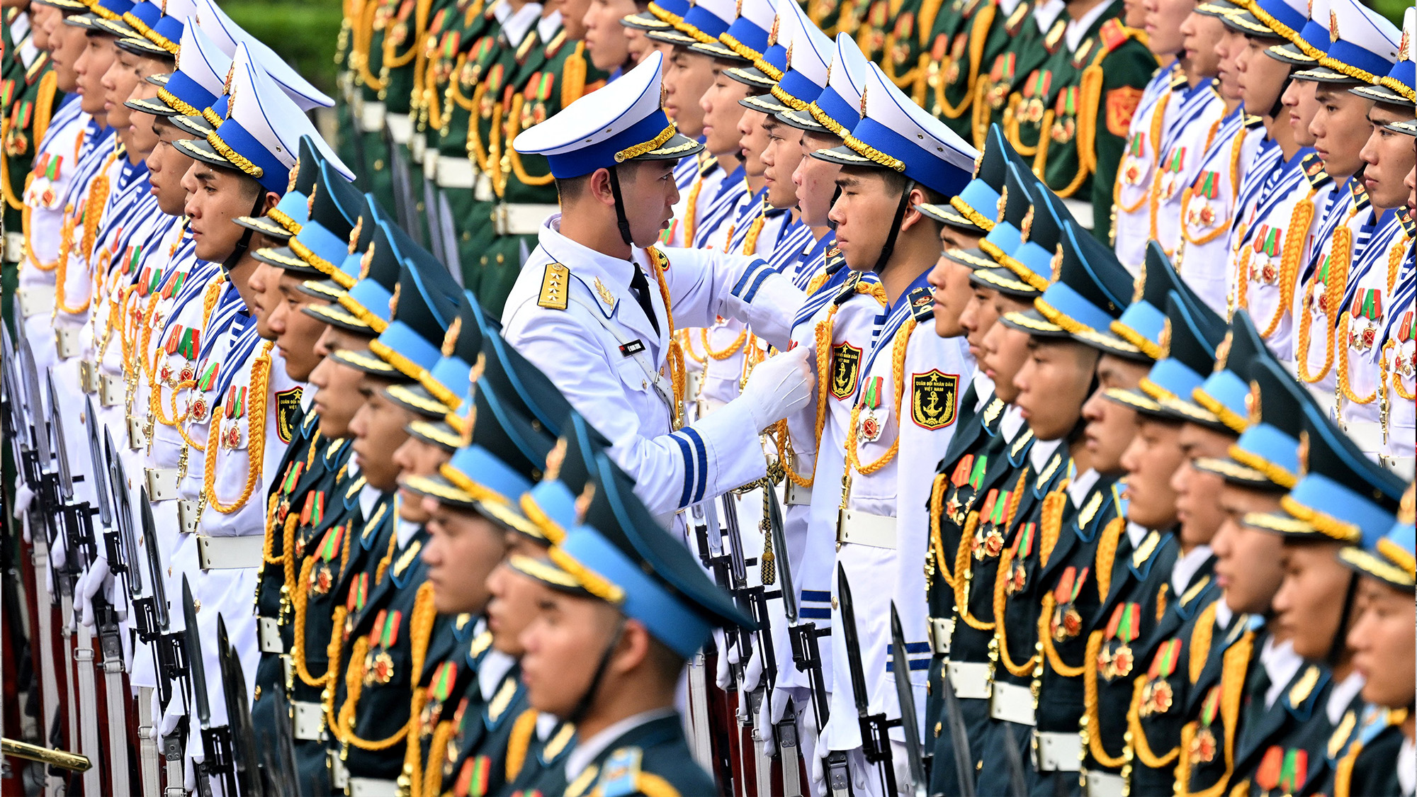 Members of a Vietnamese honour guard prepare ahead of a welcome ceremony for South Korean President Lee Jae Myung at the Presidential Palace in Hanoi, Vietnam