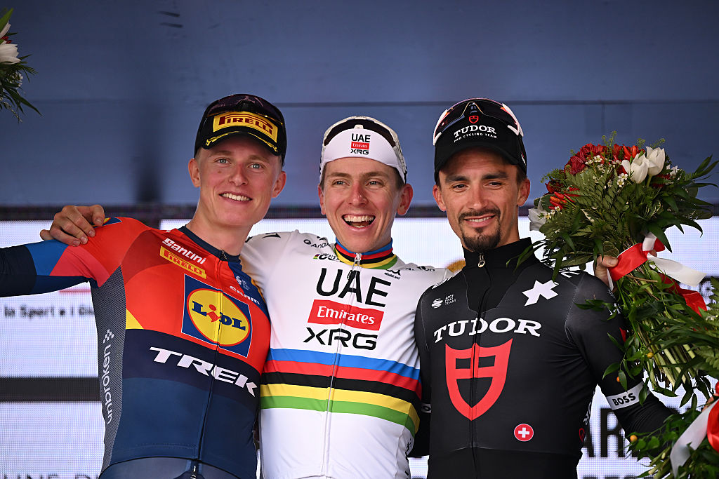VARESE, ITALY - OCTOBER 07: (L-R) Albert Withen Philipsen of Denmark and Team Lidl - Trek on second place, race winner Tadej Pogacar of Slovenia and UAE Team Emirates and Julian Alaphilippe of France and Tudor Pro Cycling Team on third place pose on the podium ceremony after the 104th Tre Valli Varesine 2025 a 200.3km one day race from Busto Arsizio to Varese on October 07, 2025 in Varese, Italy. (Photo by Dario Belingheri/Getty Images)