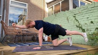 Fit & Well fitness writer Harry Bullmore performing a bird dog