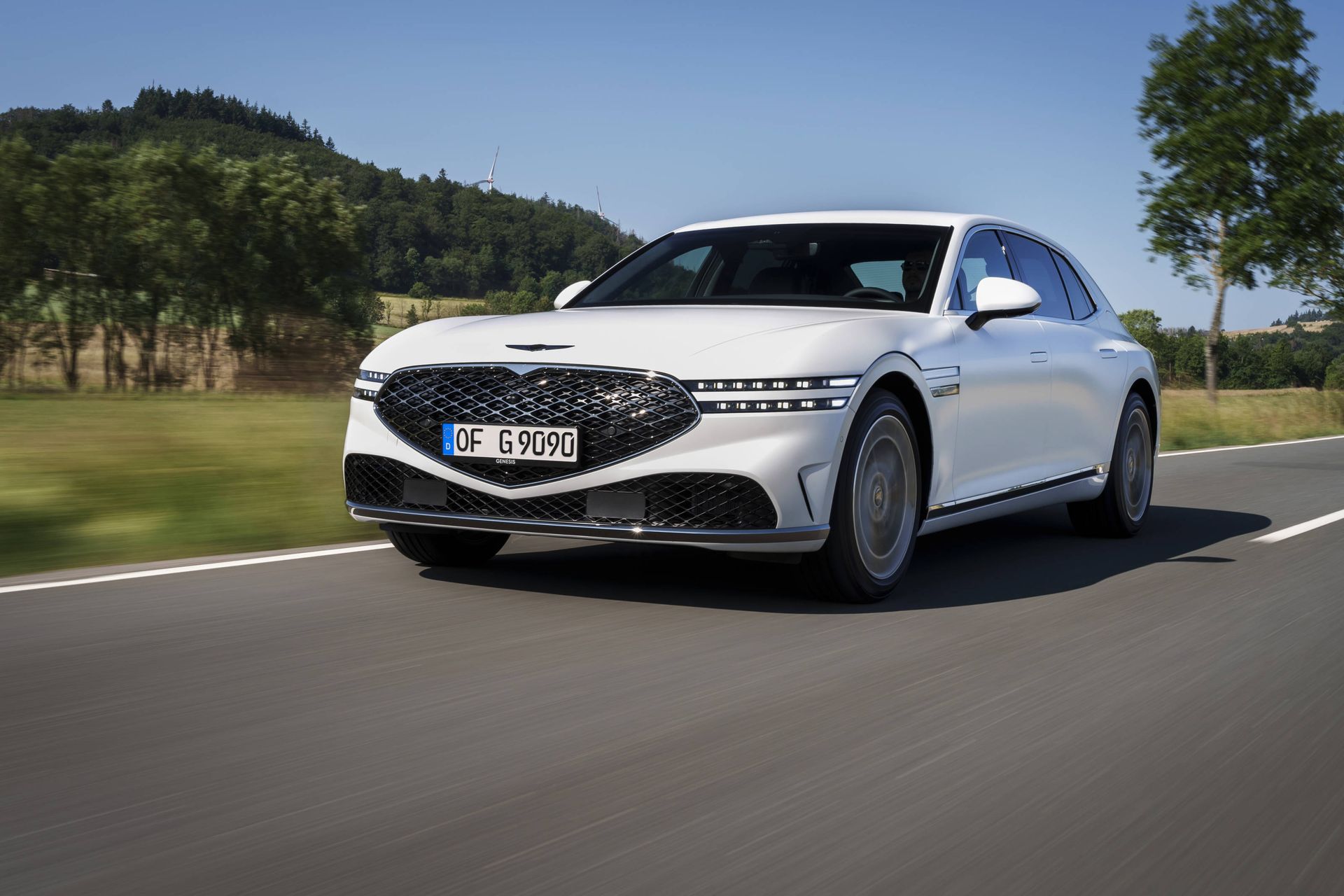 Genesis G90 on road in sunshine