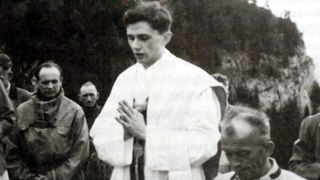 A newly ordained priest, Ratzinger prays during an open-air mass in Ruhpolding, Germany, in 1952