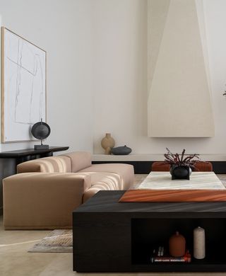 A living room with beige walls and a black console