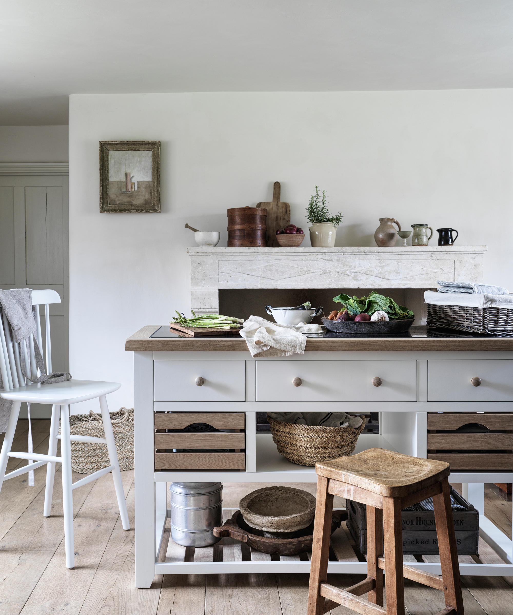 white freestanding kitchen island unit with wooden top and drawers