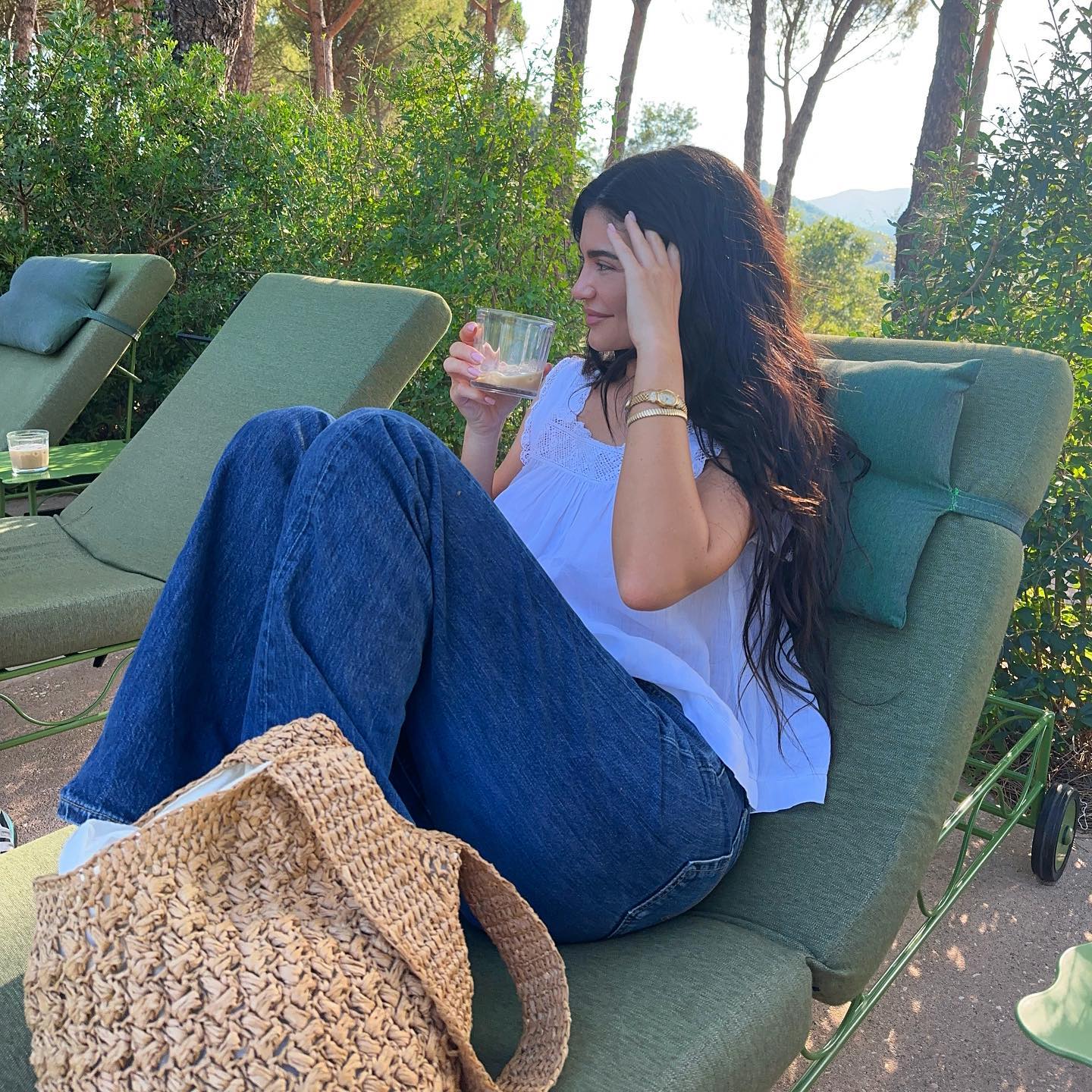 An image of @kyliejenner wearing a summer trend to wear with jeans.