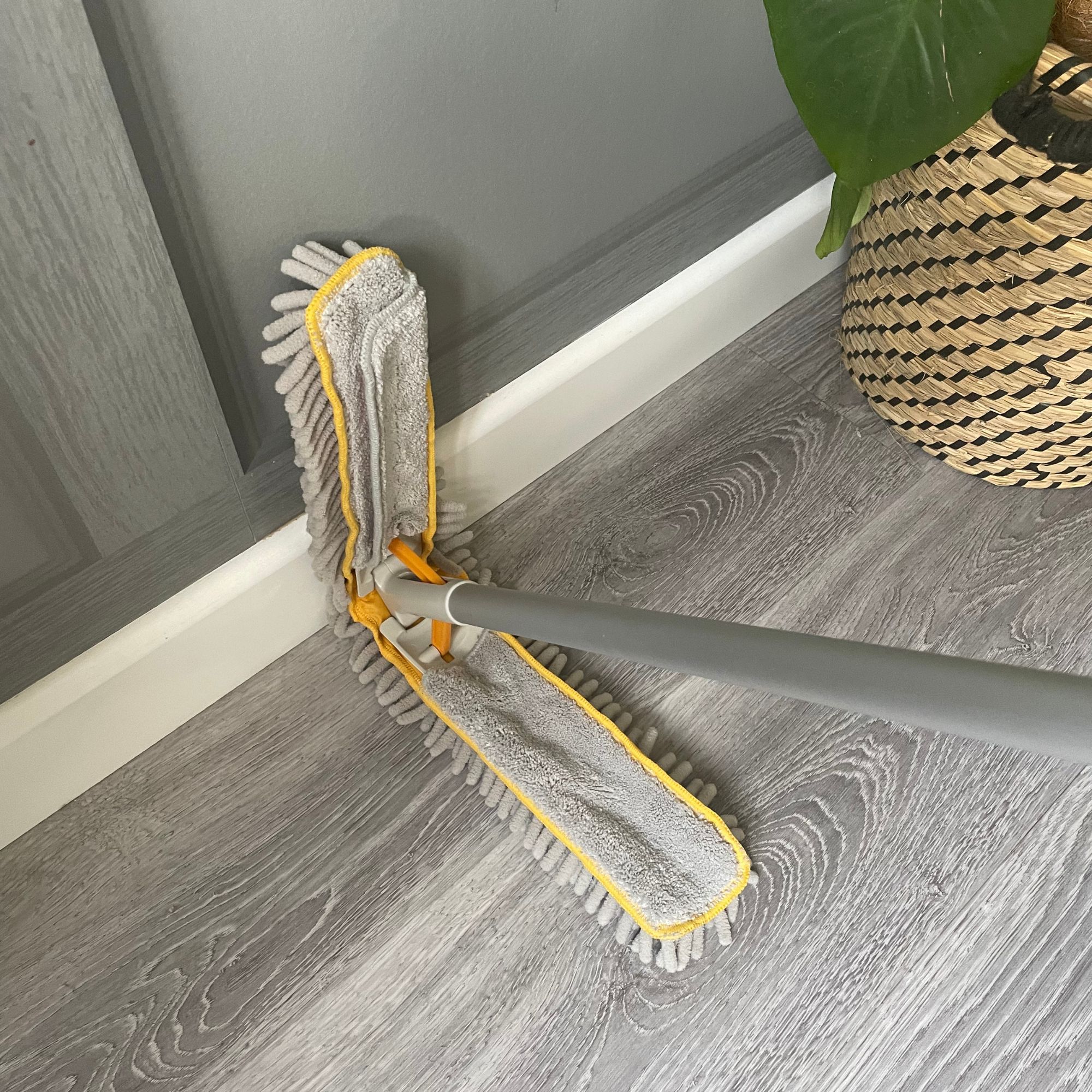Joseph Joseph low-reach duster cleaning white skirting boards and grey flooring