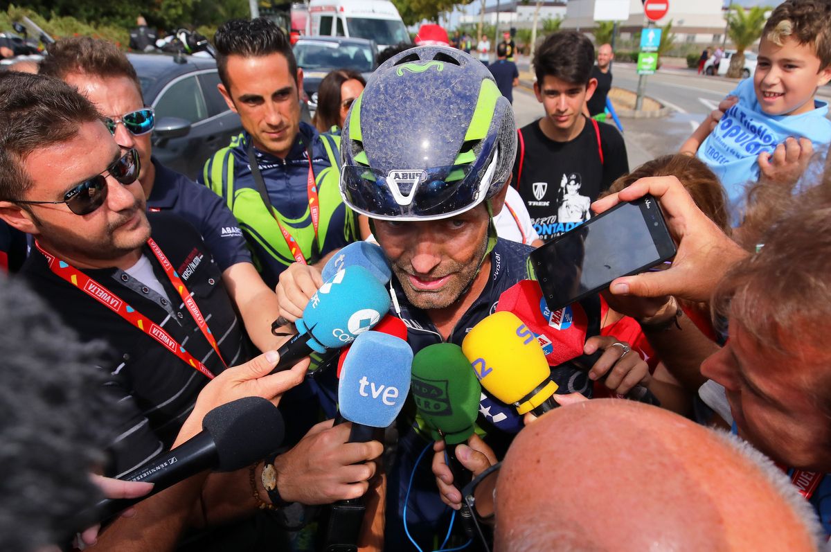 Movistar's JJ Rojas is swarmed by the media following stage 10