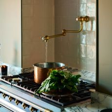 Brass pot filler on tiled backsplash
