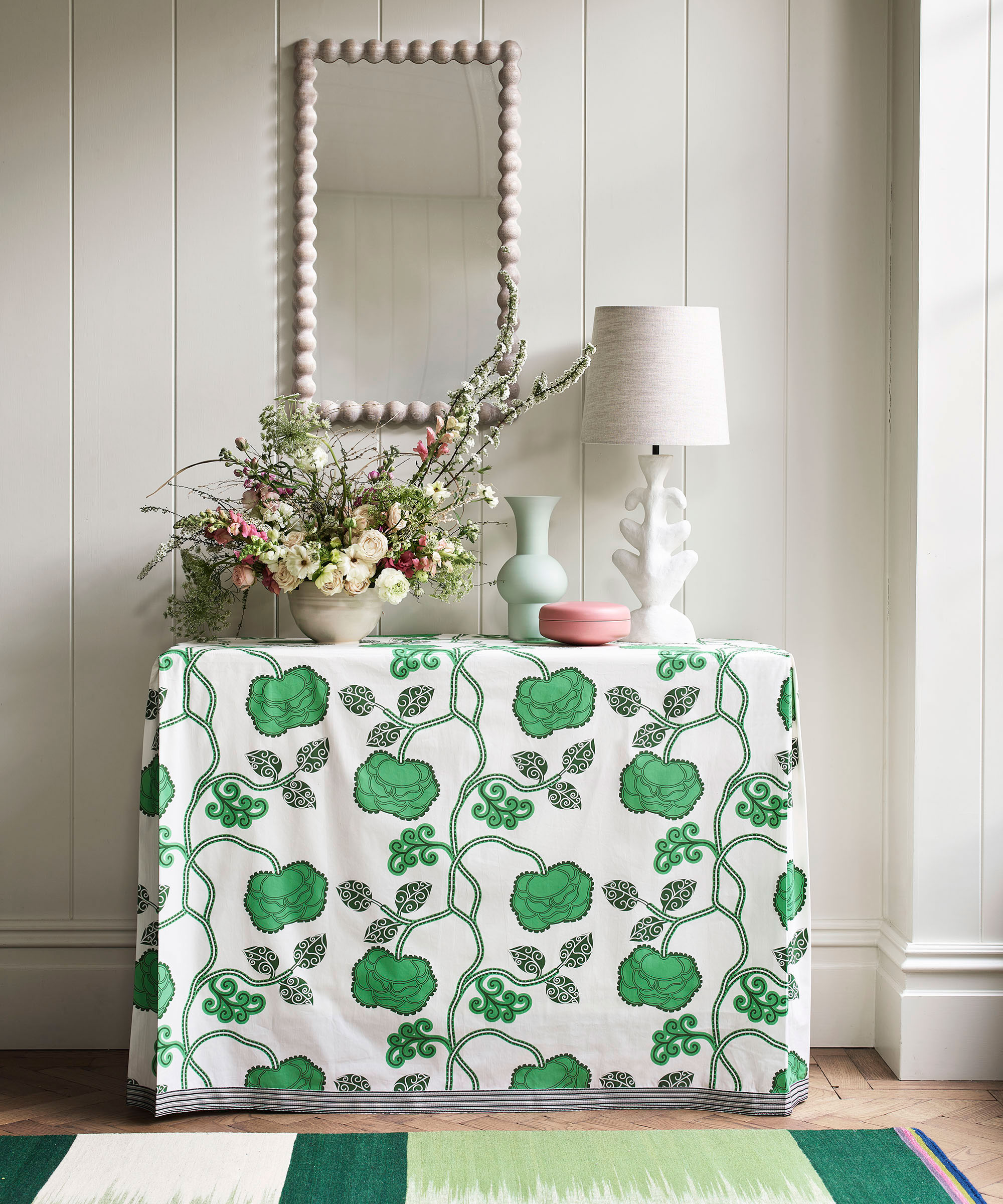 hallway console with fitted chintz table cloth and bobbin mirror