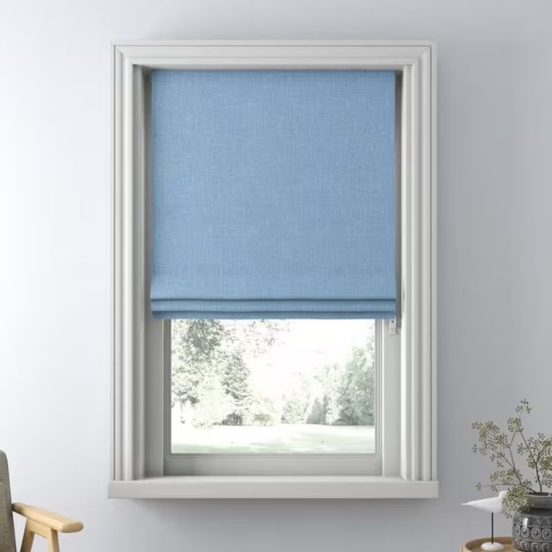 light blue Roman blinds on window with gray wall