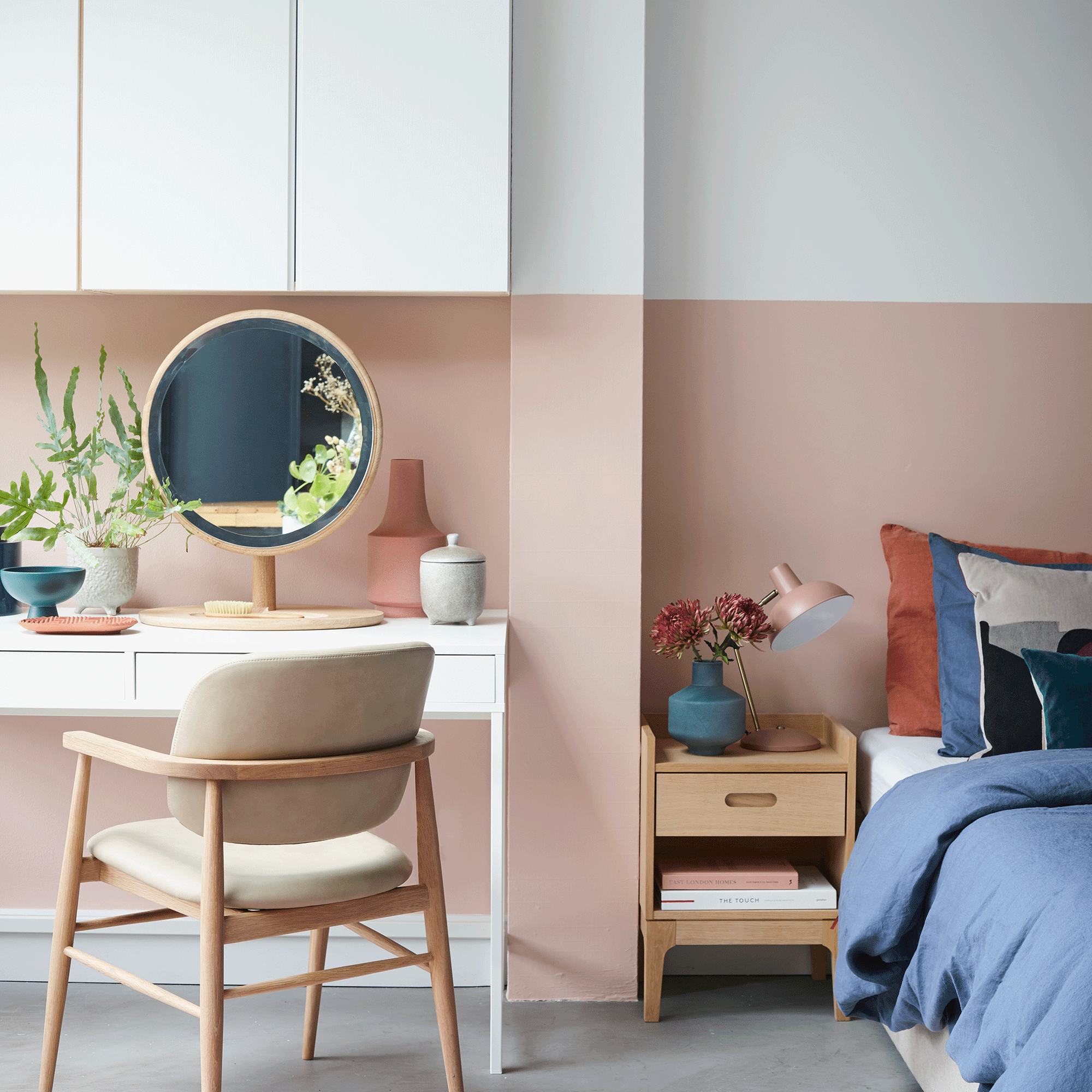 Pink and white home office with desk and mirror