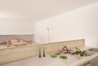 minimalist kitchen looking onto an open plan dining room