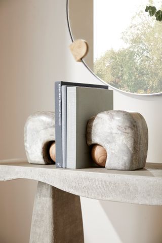 Rounded stone bookends on a fireplace