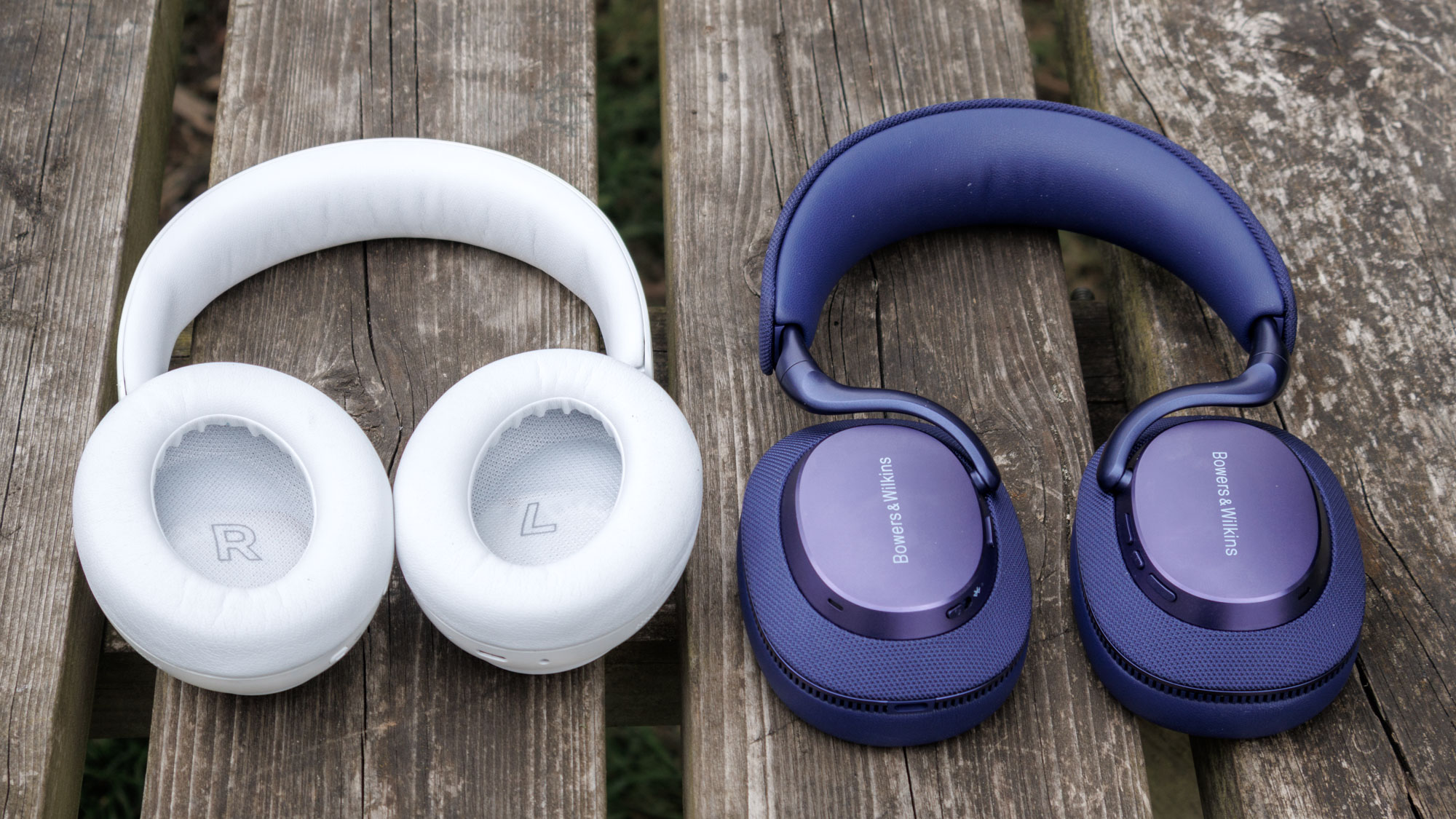 Bowers & Wilkins Px7 S3 vs Bose QuietComfort Ultra Headphones on a wooden surface, interior of the drivers