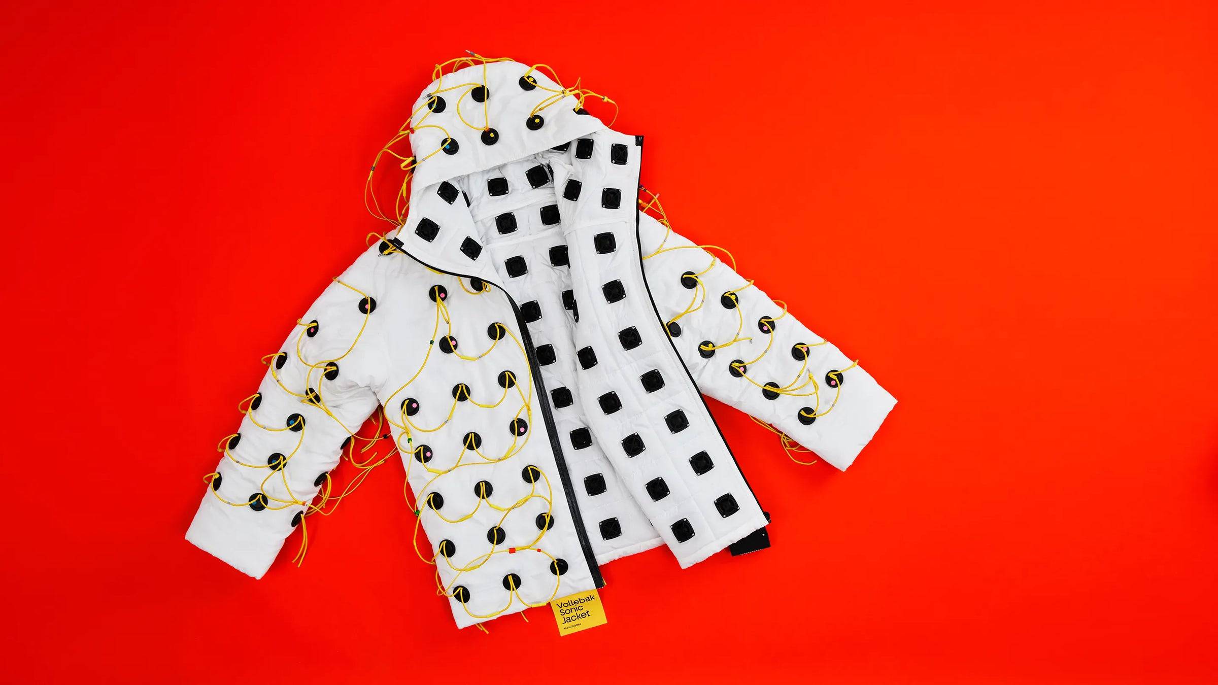 The Vollebak Sonic Jacket on a red background.