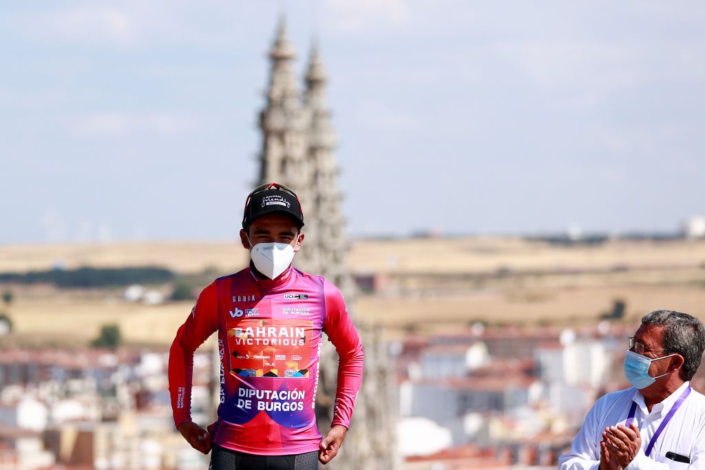 BURGOS SPAIN AUGUST 02 Santiago Buitrago Sanchez of Colombia and Team Bahrain Victorious celebrates winning the Purple Leader Jersey on the podium ceremony after the 44th Vuelta a Burgos 2022 Stage 1 a 157km stage from Catedral de Burgos to Mirador del Castillo Burgos VueltaBurgos on August 02 2022 in Burgos Spain Photo by Gonzalo Arroyo MorenoGetty Images