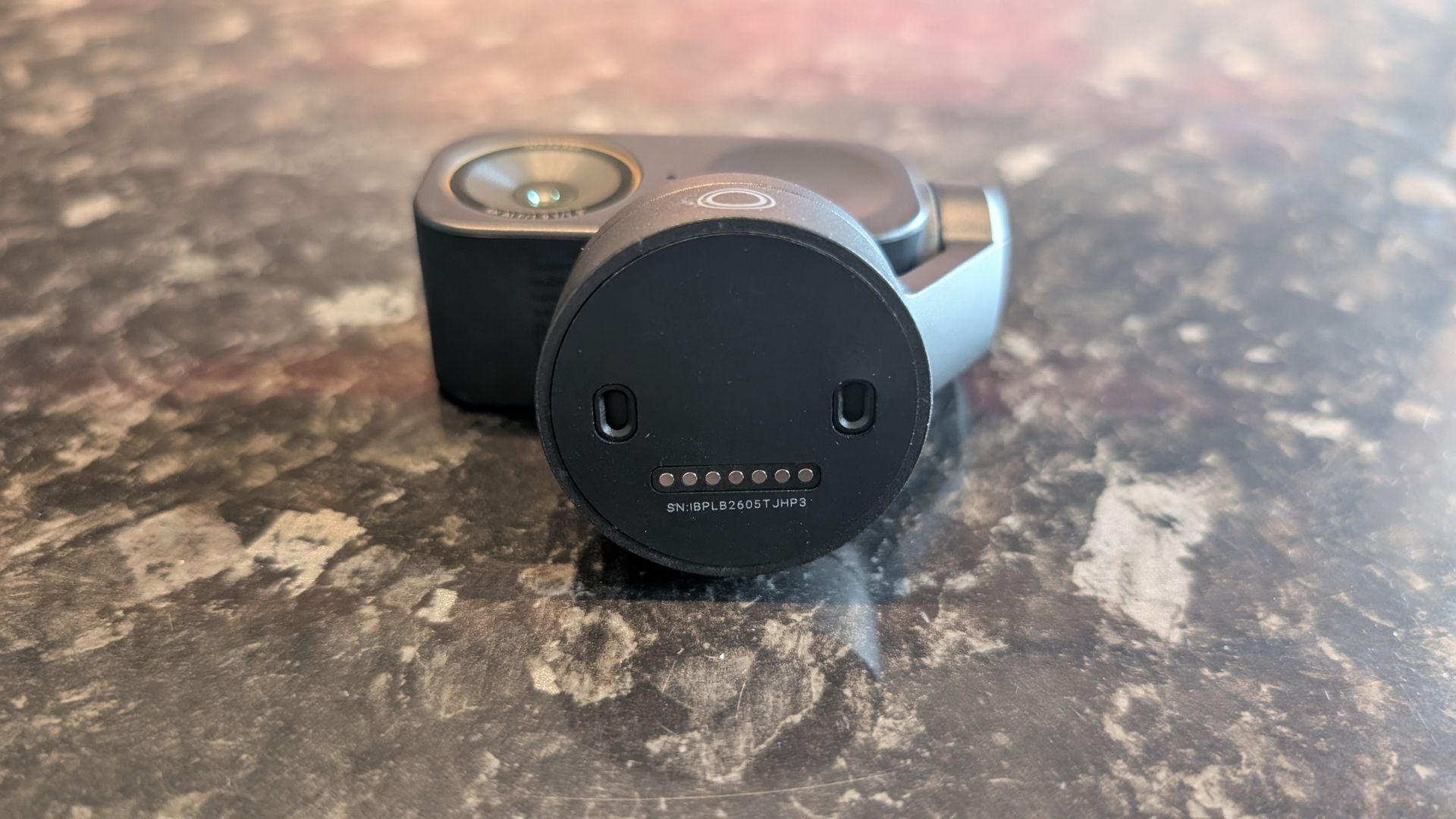 The Insta360 Link 2 Pro webcam, pictured on a marble worktop.
