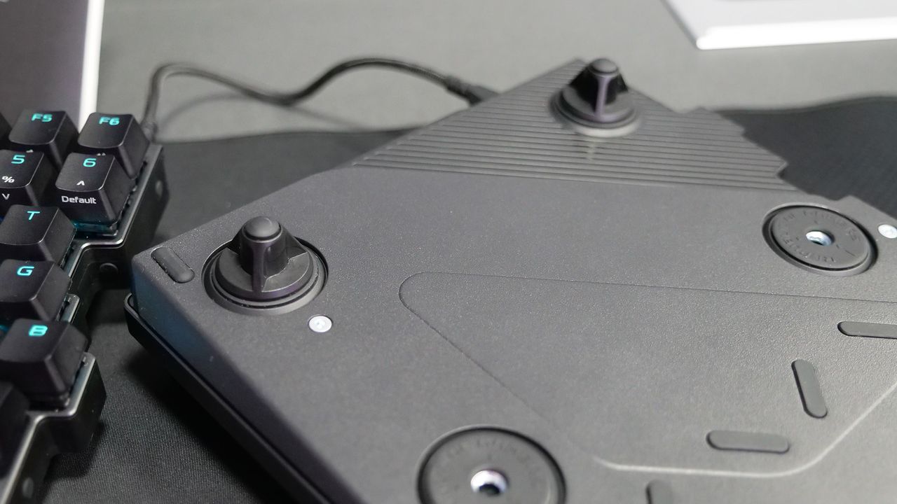 The bottom of the Asus ROG Falcata gaming keyboard showing the attachments to adjust height and angle.