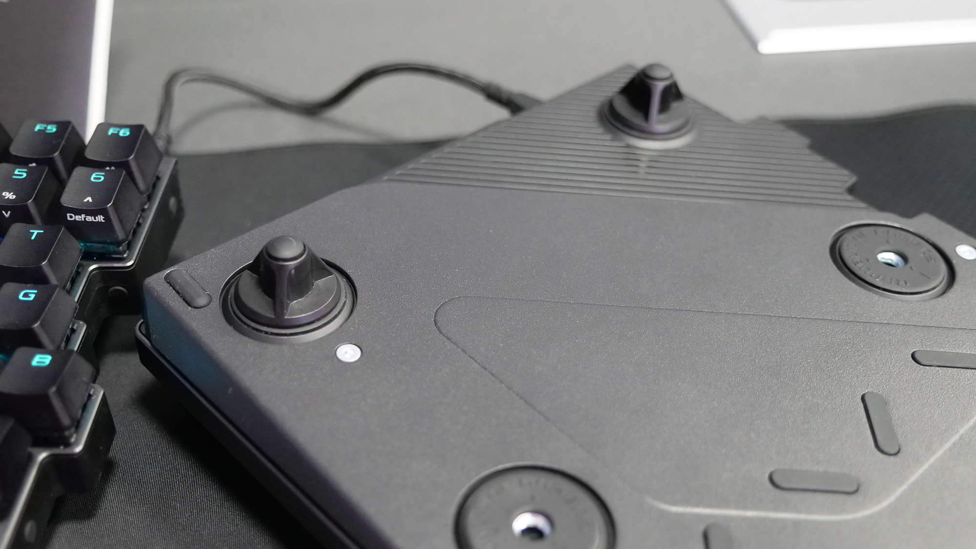 The bottom of the Asus ROG Falcata gaming keyboard showing the attachments to adjust height and angle.