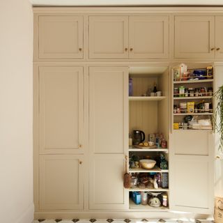 A cream shaker kitchen with a built-in pantry