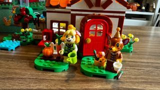 Isabelle and Fauna minifigures outside the Lego Isabelle's House Visit set