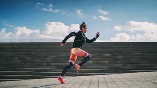 Woman trying out running tips as she sprints in city
