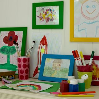 table with white walls and kids drawing
