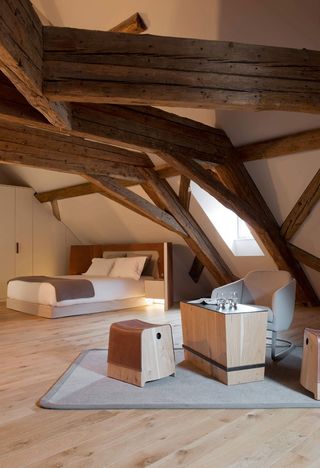 Bedroom with furniture in natural tones and featuring exposed beams