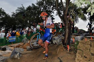 Peter Sagan runs with his bike after his puncture