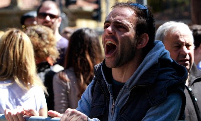 A protestor shouts slogans outside of parliament in Nicosia, Cyprus, March 18.