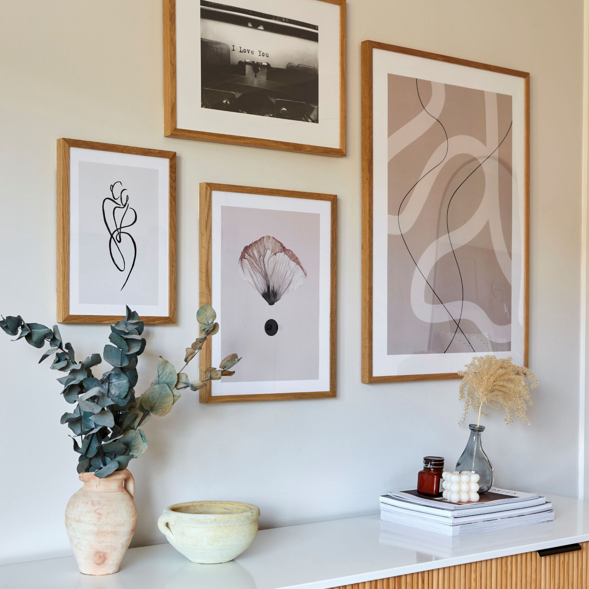 Fluted oak dresser with plants and home decor furnishings displayed, gallery wall